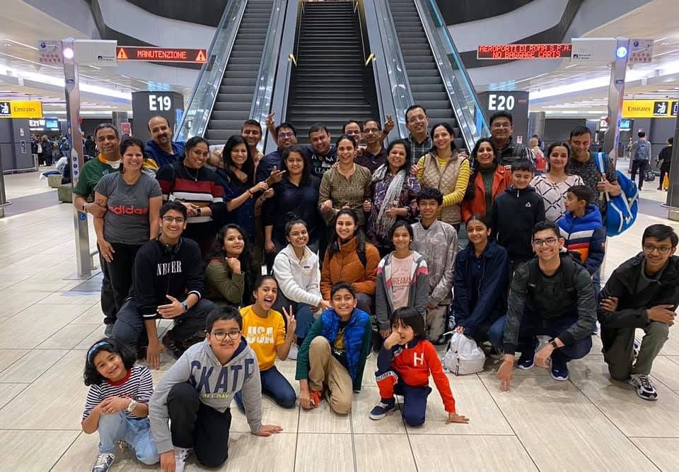 Group trip photo at an airport